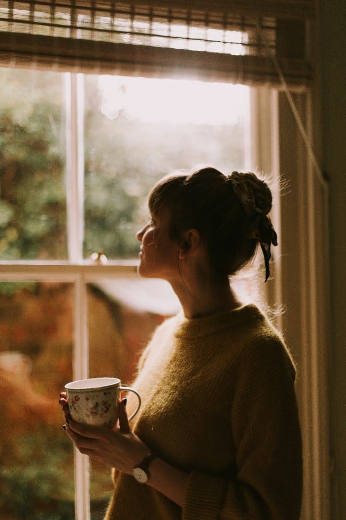 Woman enjoying a cup of herbal tea at home